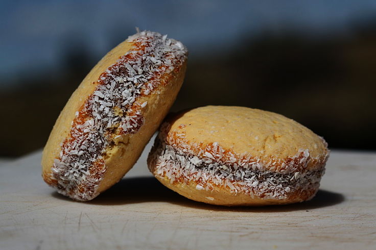 Alfajores are soft, delicate, cookie sandwich treats made with shortbread rounds and caramel (dulce de leche) filling rolled in coconut