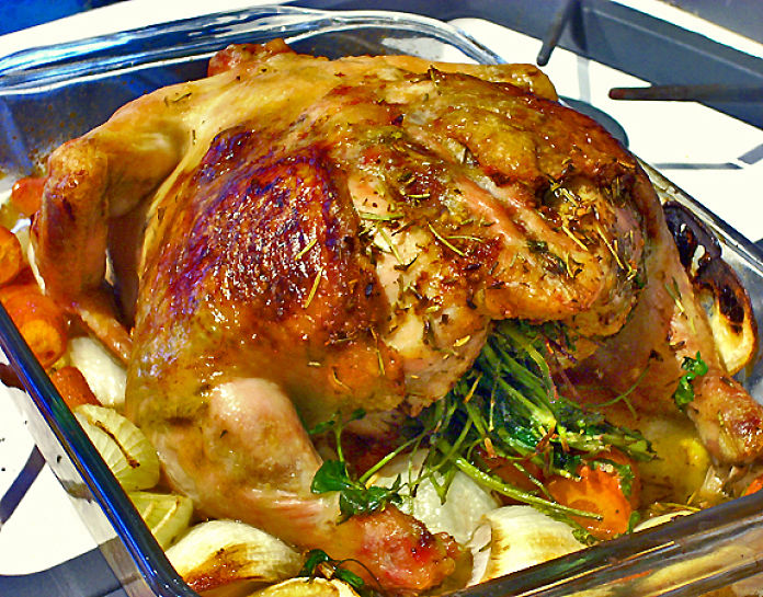 Lovely baked chicken stuffed with herbs and served with fresh steamed vegetables