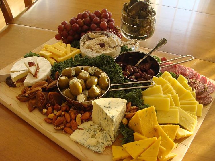 A lovely layout with a selection of cheeses, olives, fruit and nuts - Looks to good.