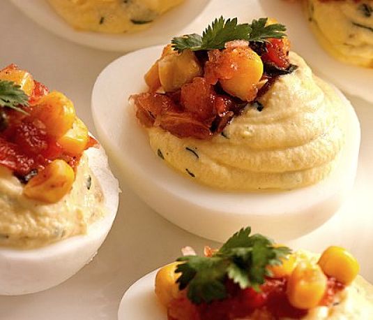 Deviled eggs with herbs and crispy bacon - see more recipes here