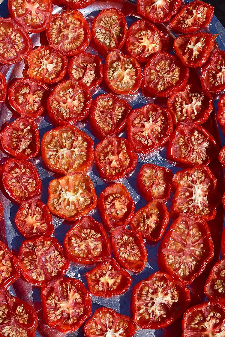 Turn the dried tomatoes once or twice to ensure even drying when preparing dried tomatoes in your oven.