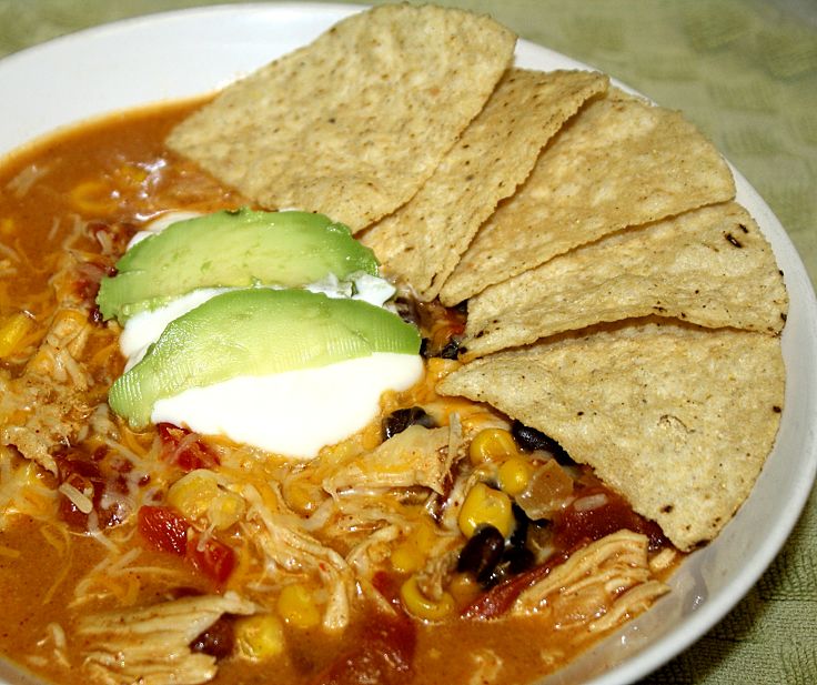 This soup has all the flavor of enchiladas and is served with avocado cream and shredded chicken