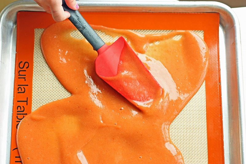 Spreading the mixture onto the fruit leather mat