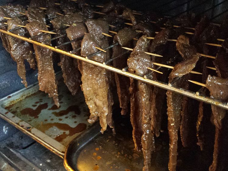Marinated strips being added to the drier.