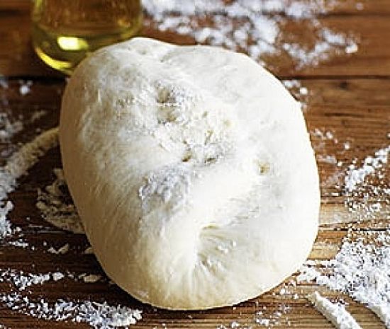 Rolling the pizza dough into a ball after kneading