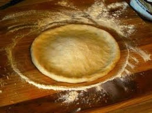 The dough shaped to fit the pan with relatively high perimeter ridge to help contain the rich thick filling you are going to add