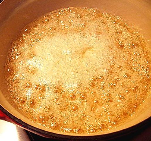The bicarbonate reacts with the hot toffee generating a mas of carbon dioxide bubbles that cause the mixture to expand to 4-5 its original volume