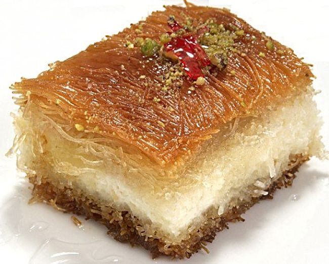  Various options are available for the base and crust of the knafeh. Slice into squares and serve with a sugar syrup.