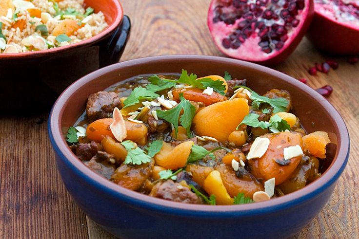 Fragrant Moroccan style lamb tagine with dried fruits served with spiced cous cous