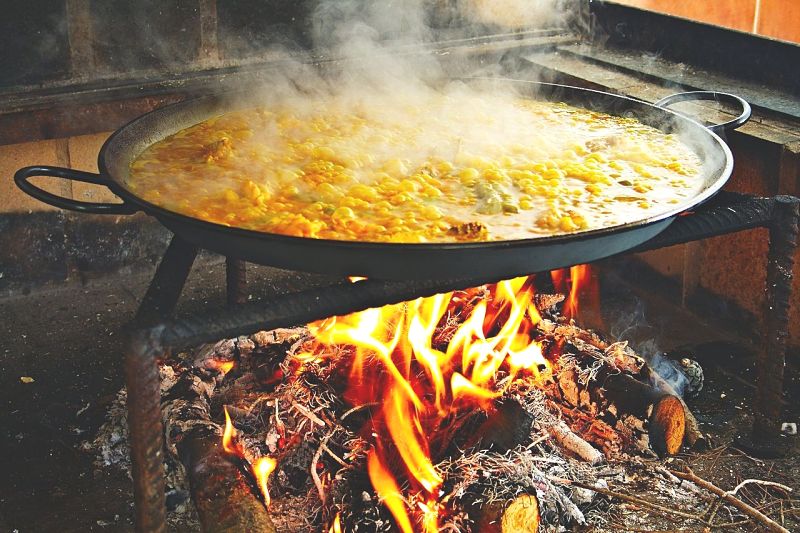 Paella is traditionally cooked over an open fire. Inside you can use a wok burner or your stove, two burners or a single one. Ensure the pan is rotated to ensure even cooking.