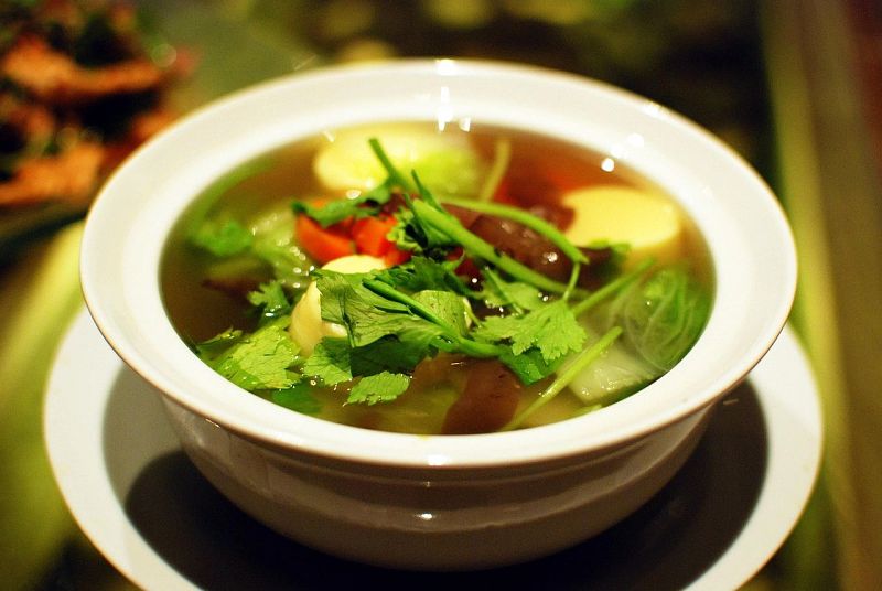 A light broth (here a vegetable broth but pork and/or chicken is also common) with soft tofu, stir fried pork and vegetables