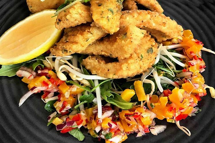 Salt and pepper fish filet strips with a delightful colored salad.