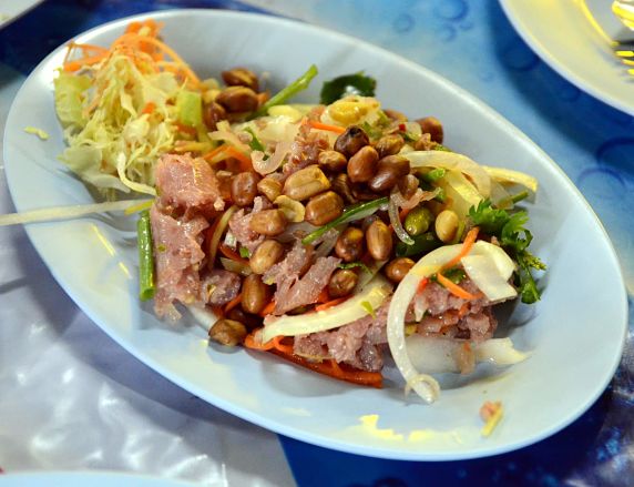 Thai salad made from fermented raw pork and sticky rice (naem) with peanuts and herbs.