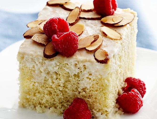Tres Leches cake with raspberries and toasted almond slivers