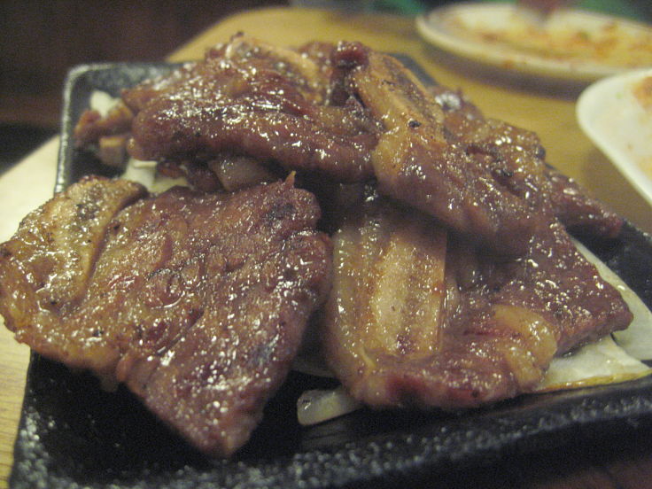 Korean short ribs cook fast on a barbecue after several hours of marinading to enhance the flavors of the roast meat 